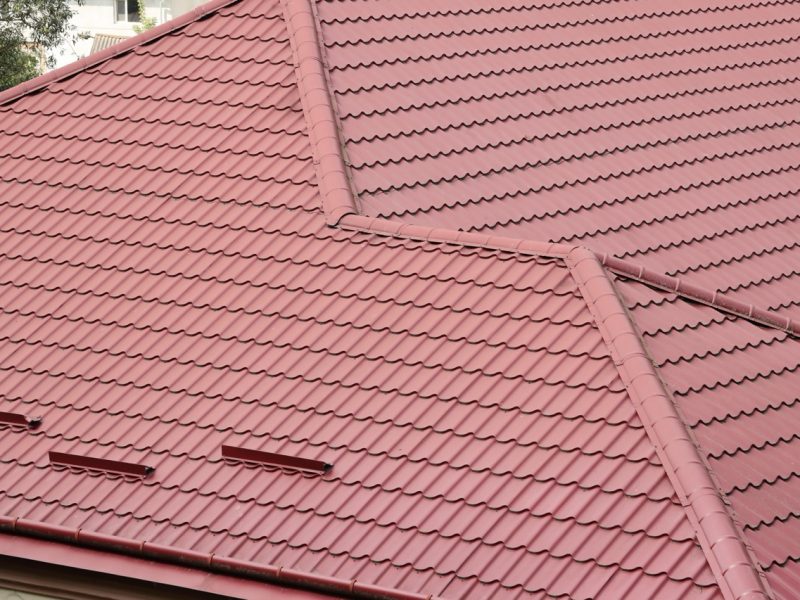 Decorative metal roof tiles in shape of old shingles. Type of roof of the house from a metal profile close up